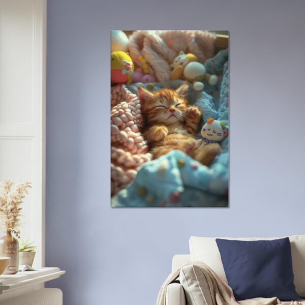 A Sleeping Kitten Canvas Print hangs on a blue wall above a white couch with navy pillows. A plant sits on a nearby wooden table.